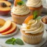 honey peach cream cheese cupcakes arranged on white marble surface